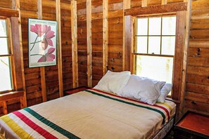 A wooden cabin room with a bed, a poster on the wall, and a window. - Cozy 2BR Dog Friendly - Beach Down the street (Moultonborough)