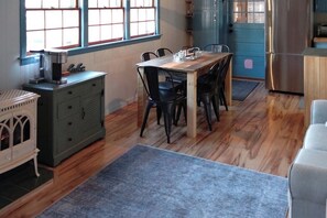 A dining area with a wooden table and chairs, a coffee machine, and a refrigerator. - 3BR - Dock - Fireplace - Deck - Tennis (Meredith)