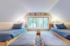 A room with two beds, a window, and a skylight. - Serene 3BR Dog Friendly - Sauna - Balcony (Gilford)