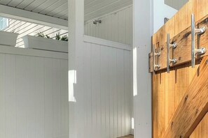 A wooden gate with metal hardware, white wooden panels, and a metal latch. - 3BR Fully renovated, dog friendly home (Meredith)