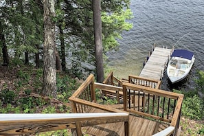 A wooden dock extending into a lake, surrounded by trees. - 1BR cottage with beach access & dock (Alton)