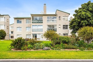 A multi-story residential building with a flat roof, large windows, and a well-maintained garden in front. - Annies Haven at Greenways Golf Estate (Cape Town)