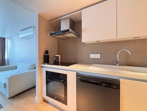 A modern kitchen with integrated dishwasher, oven, and a built-in stove. - Chic 1BR near Karaköy and Galataport (Istanbul)