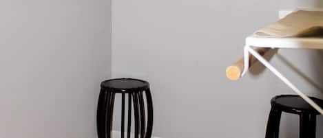 A room with a wooden floor, a white ceiling, and a grey wall.