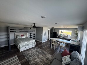 Espaço compacto para vivenda, com beliche, cozinha compacta e área de refeições.