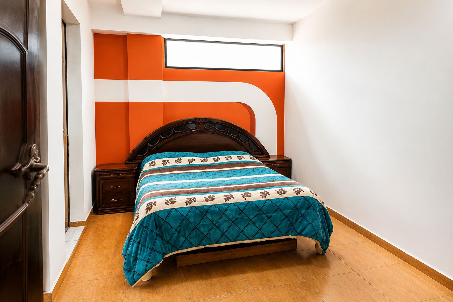 A bedroom with a bed, wooden nightstands, a dark wooden headboard, and a white and orange wall design.