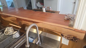 A kitchen with a wooden countertop, stainless steel sink, and a dish rack. - Fully Remodeled and Updated, just 90-mins from San Francisco! (Monte Rio)