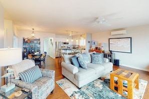A spacious living area with a sofa, a coffee table, and a dining table. - Prime 1BR Oceanfront Dog Friendly - Patio - Washer Dryer (Port Angeles)