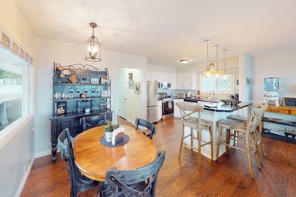 A modern kitchen with white cabinets, stainless steel appliances, and a central island. - Prime 1BR Oceanfront Dog Friendly - Patio - Washer Dryer (Port Angeles)