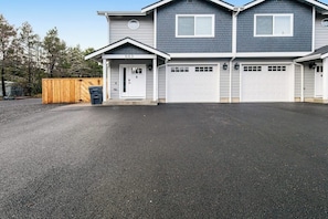 A two-story residential building with a garage and a driveway. - Modern 3BR Dog Friendly - Hot Tub - Patio (Westport)