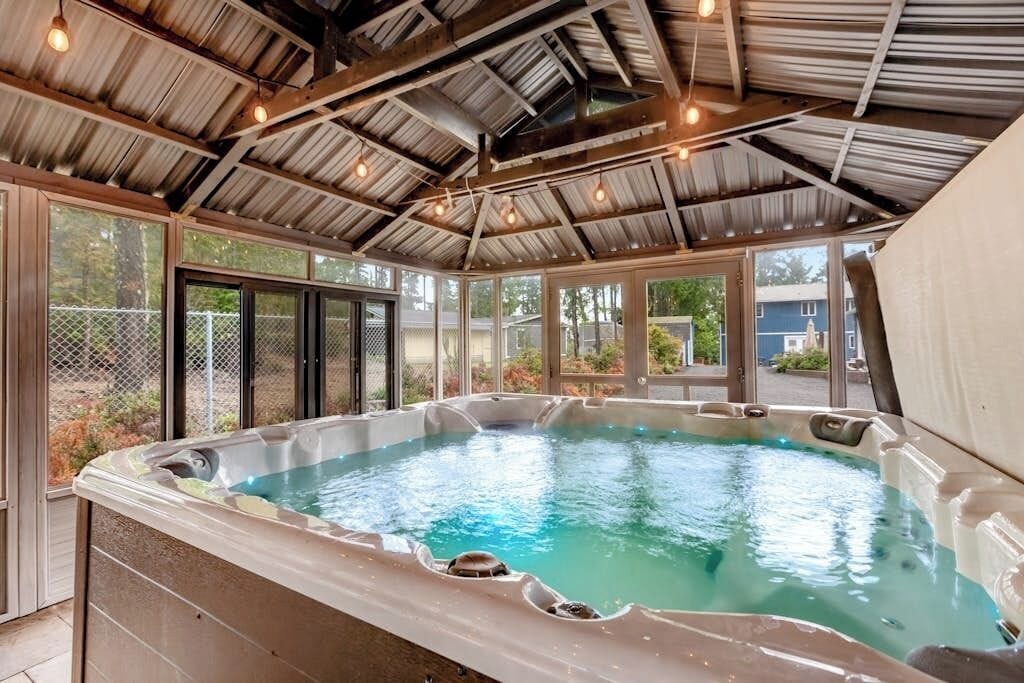 A hot tub with a metal roof and large windows.
