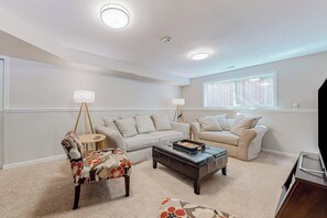 A living room with two sofas, a coffee table, and a lamp.