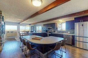 A modern kitchen with a central island, built-in appliances, and a stone accent wall. - Spacious 3BR Bayview Dog Friendly - Balcony (Westport)