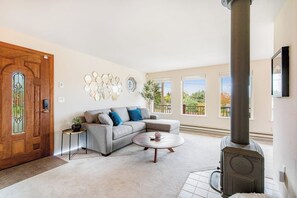 A living room with a sofa, coffee table, and a fireplace. - Comfortable 3BR - Deck - Washer Dryer (University Place)