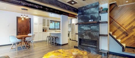 A modern interior with a dining area, kitchen, and living space.