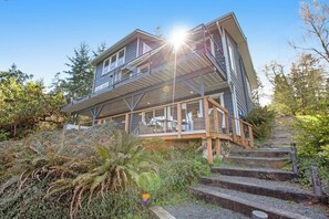 A two-story house with a balcony, surrounded by vegetation. - Impeccable 3BR Oceanview Dog Friendly - Hot Tub (Port Ludlow)
