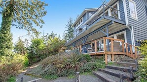 A multi-level house with outdoor staircases and a deck. - Impeccable 3BR Oceanview Dog Friendly | Hot Tub (Port Ludlow)