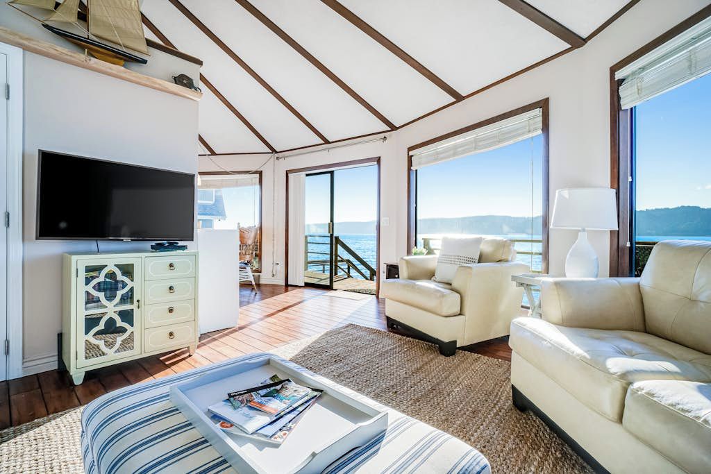 A spacious living area with a television, a sofa, and a coffee table.