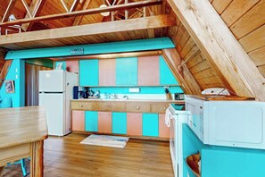 A compact kitchen with a wooden ceiling, a refrigerator, a sink, and a microwave. - 1BR with loft escape with expansive deck, gas grill (Gig Harbor)