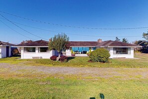 A single-story house with a front porch, a garage, and a well-maintained lawn.