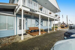 A building with a porch, a bench, and a sign with the number 2115. - Incredible 2BR Bayview 1st-Floor (Westport)