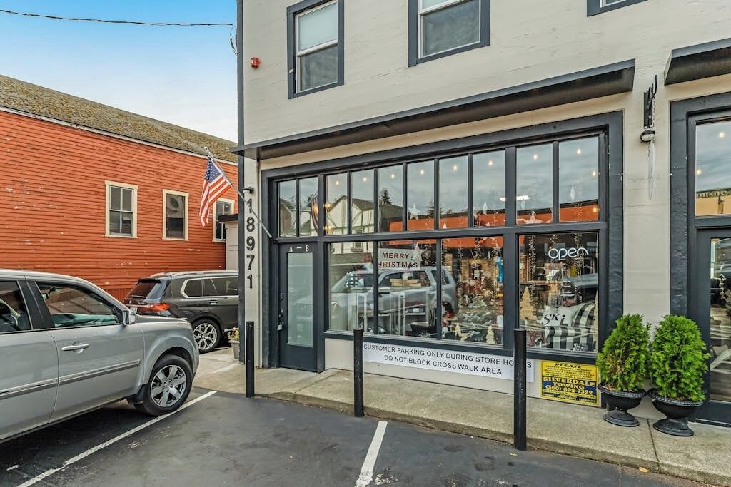 A storefront with large windows and a sign that reads 'Merry Christmas.'