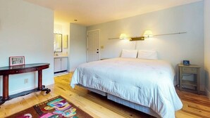 A bedroom with a double bed, bedside tables, a nightstand, a mirror, and a door. - 2 BR condo with stunning water views (Port Ludlow)