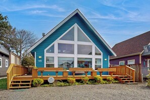 A two-story building with a prominent gable roof and a large central window. - 2BR Oceanview Dog Friendly - Fireplace - Deck (Pacific Beach)