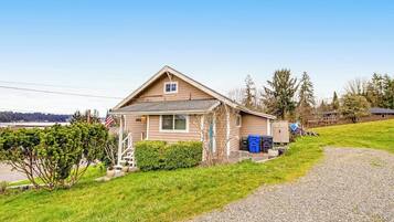 A single-story house with a sloped roof, a front porch, and a small front yard.