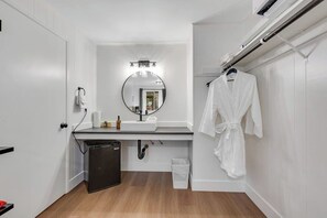 A modern bathroom with a white sink, mirror, and towel rack. - Dog-Friendly Studio - 1st-Floor - Mountain Views (Quilcene)