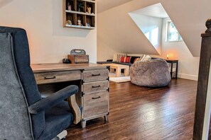A loft-style room with a desk, chair, and bean bag. - Rare cabin with deck, fire pit (Ronald)