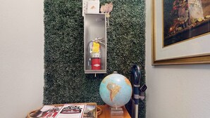 A small table with a globe, a fire extinguisher, and a basket with brochures. - 1BR Hotel Room right in Downtown Port Townsend (Port Townsend)