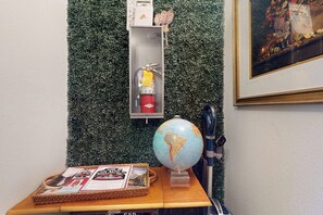 A small table with a globe, a fire extinguisher, and a basket with brochures. - 1BR Hotel Room right in Downtown Port Townsend (Port Townsend)