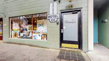 A hotel entrance with a sign reading 'HOTEL 825' and a door labeled 'THE WASHINGTON.'