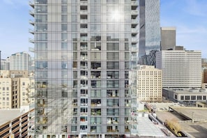 A high-rise building with multiple floors, large windows, and balconies. - 1BR condo near attractions with pool & hot tub (Seattle)