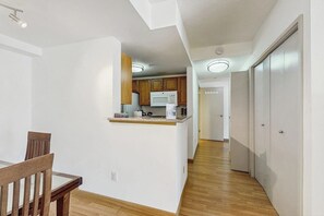 A modern kitchen with wooden cabinets, a microwave, and a countertop. - 1BR condo near attractions with pool & hot tub (Seattle)