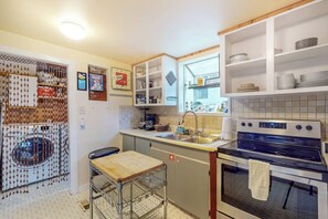 A compact kitchen with a built-in oven, a sink, and a coffee maker. - Original 3BR - Dog Friendly - Amazing Bay Views (Seattle)