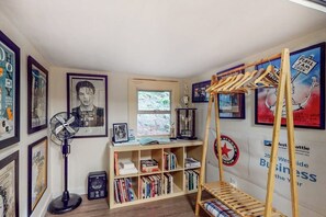A room with a bunk bed, a bookshelf, a fan, and various posters on the walls. - Original 3BR - Dog Friendly - Amazing Bay Views (Seattle)