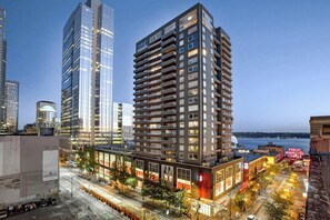 A high-rise building with multiple floors, large windows, and a modern architectural design. - Luxury 2BR Bayview Washington State Conv. Center 2 (Seattle)