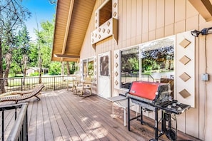 A covered outdoor area with a barbecue grill, wooden deck, and outdoor seating. - 2BR lakefront cabin with private dock (Cle Elum)