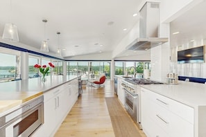 A modern kitchen with a large island, stainless steel appliances, and a view of the outdoors. - 5 BR Luxury Waterfront Retreat in Gig Harbor (Gig Harbor)