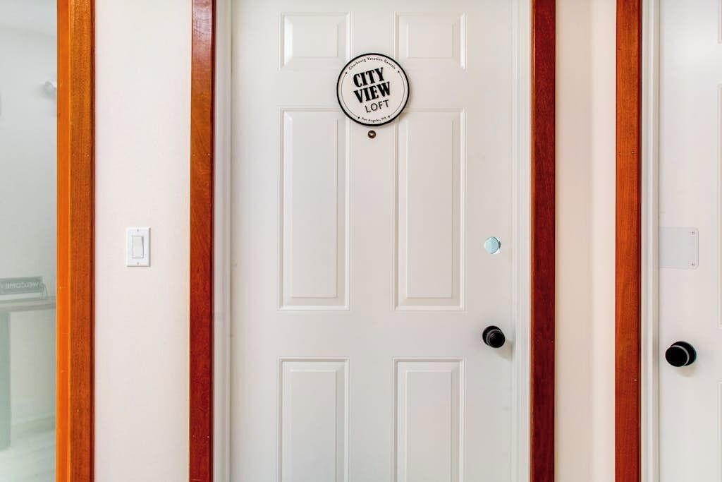 A white door with a circular sign that reads 'CITY VIEW LOFT'.