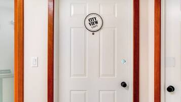 A white door with a circular sign that reads 'CITY VIEW LOFT'.
