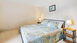 A bedroom with a bed, two bedside tables, a wall-mounted picture, and a carpeted floor. - 1BR Soundview Dog Friendly - Dock - WoodStove (Shelton)