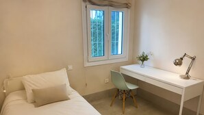 A bedroom with a bed, a desk, and a chair. - Villa Playa de Roche: private pool, 1000m² garden, 2 en suite bathrooms (Roche)