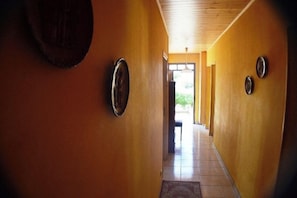 A hallway with a wooden ceiling and a door at the end. - "Au Grand Bonheur" Villa, with a pool, sleeps 15 (Grospierres)