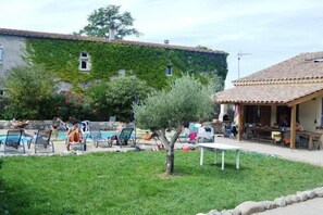 A courtyard with outdoor seating, a pool, and a building with a tiled roof. - "Au Grand Bonheur" Villa, with a pool, sleeps 15 (Grospierres)