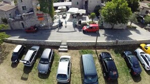 A parking lot with multiple cars and a building with a sign that reads 'Ristorante'. - Vacation Rental #8, Sleeps 6, Domaine de Ribière (Grospierres)