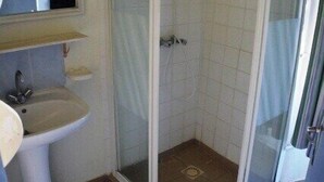 A bathroom with a glass-enclosed shower, a pedestal sink, and a mirror above the sink. - Vacation Rental #8, Sleeps 6, Domaine de Ribière (Grospierres)