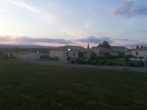 A residential area with houses, a grassy field, and a clear sky. - "Chez Nous" Villa, with Air Conditioning, Pool, BBQ, and Terrace (Grospierres)